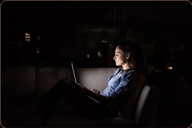 a-woman-working-on-a-laptop-at-night-at-home