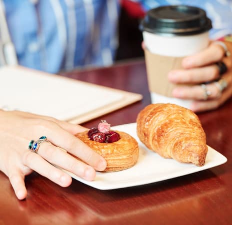 woman-having-coffee-and-cherry-pastry